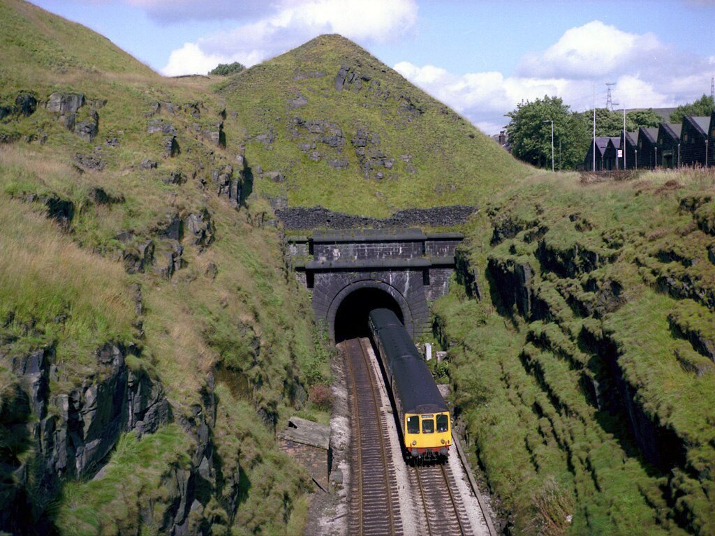 Summit Railway Tunnel showing train Ingy The Wingy, CC BY-SA 2.0 , via Wikimedia Commons. Summit_Tunnel_Littleborough_Class_110_1982